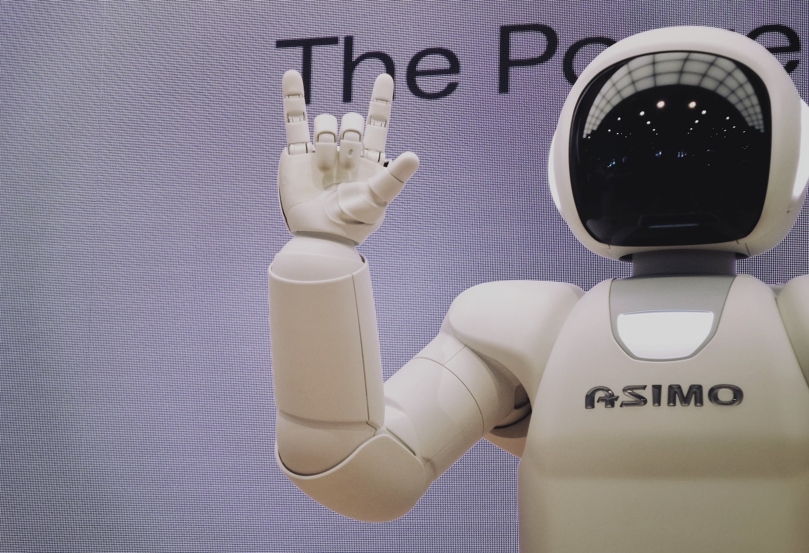 Asimo famous AI robot doing handsign